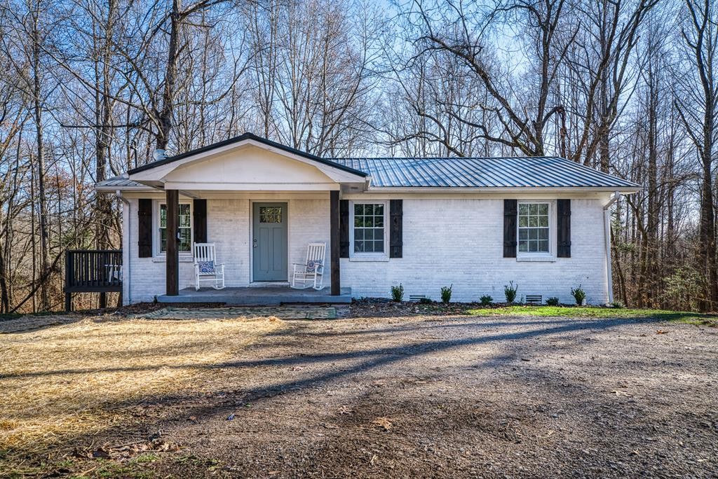 329 Sunny Point Road Baxter, TN 38544 - Photo 1 of 25 a front view of a house with a garden