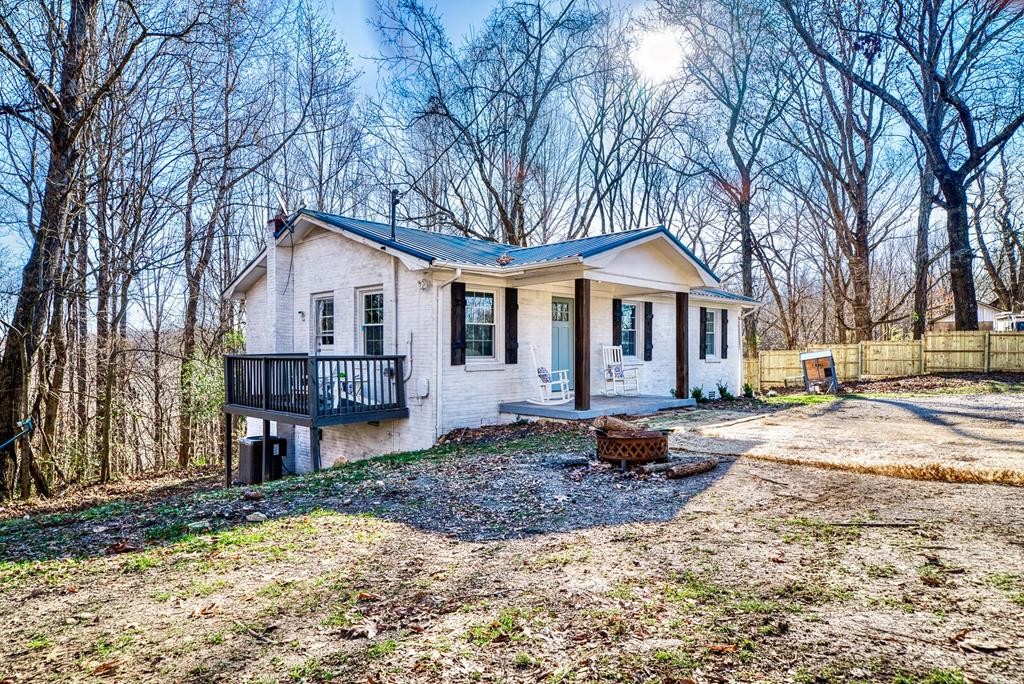 329 Sunny Point Road Baxter, TN 38544 - Photo 21 of 25 a front view of a house with a yard and large trees