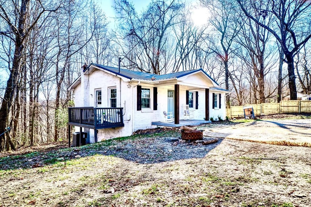 329 Sunny Point Road Baxter, TN 38544 - Photo 24 of 25 a front view of a house with a yard outdoor seating and barbeque oven
