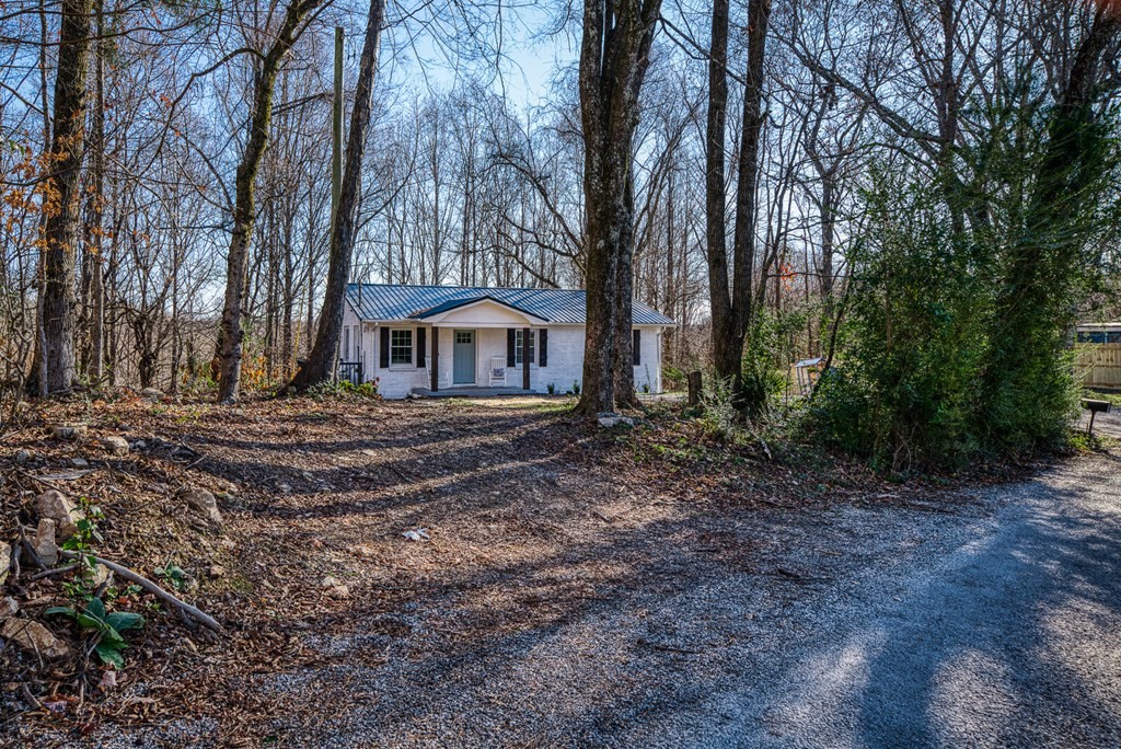 329 Sunny Point Road Baxter, TN 38544 - Photo 6 of 25 a front view of a house with a yard