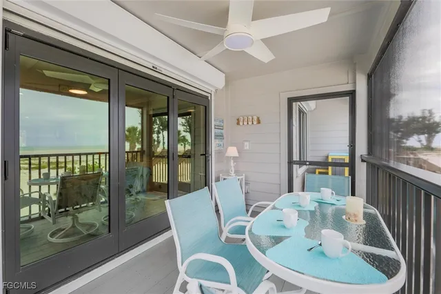 a dining room with furniture wooden floor and a chandelier