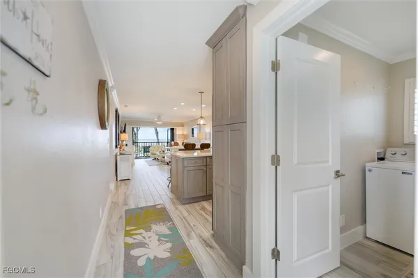 a view of kitchen and hall with wooden floor