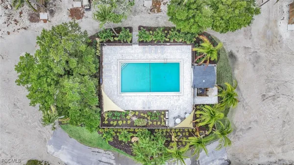 an aerial view of a house with a yard and potted plants