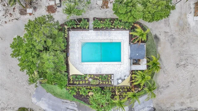 an aerial view of a house with a yard and potted plants