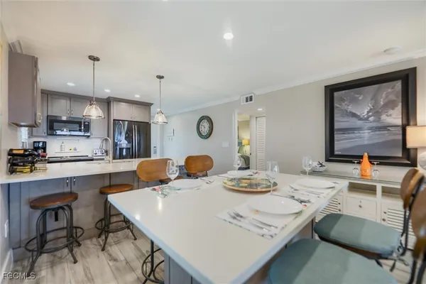a kitchen with a table chairs and a refrigerator