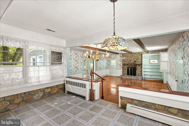 a living room with furniture and a chandelier