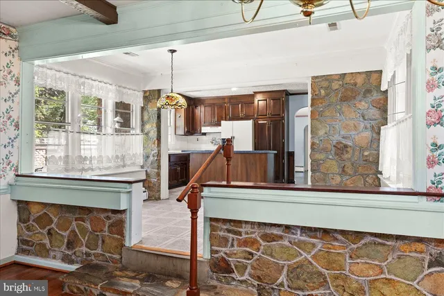 a dining room with wooden floor and windows