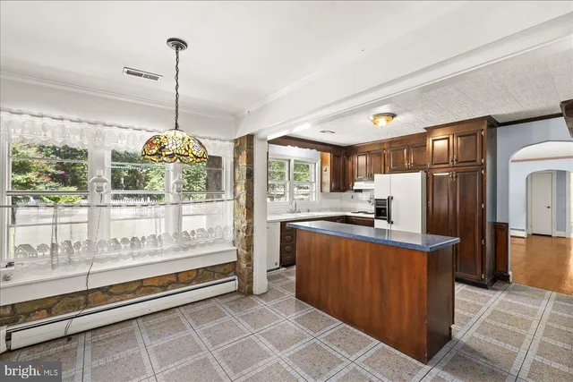 a kitchen with stainless steel appliances granite countertop a refrigerator a sink and dishwasher