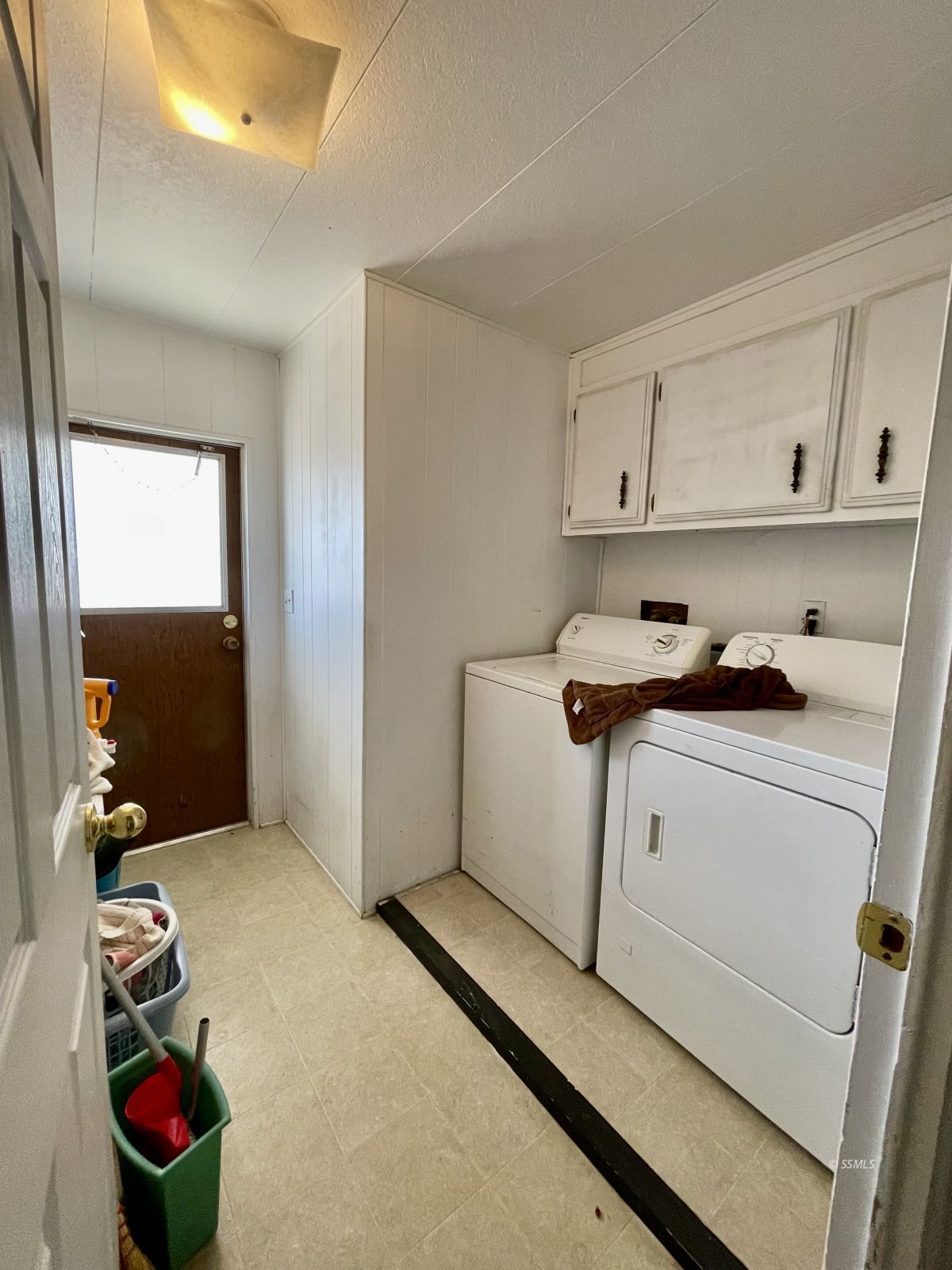 5237 Nolina Avenue Ridgecrest, CA 93555 - Photo 13 of 27 a utility room with cabinets washer and dryer