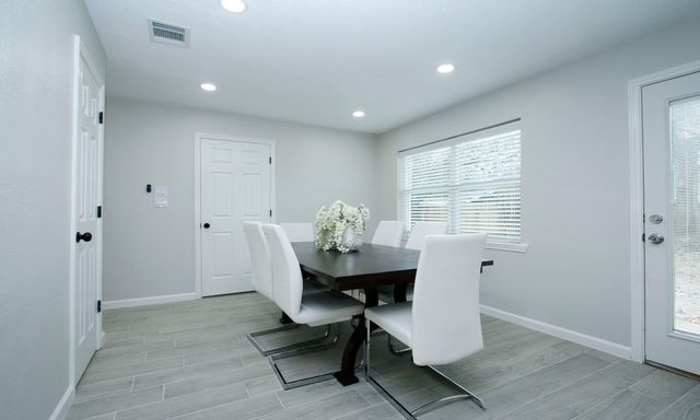 a workspace room with furniture and window