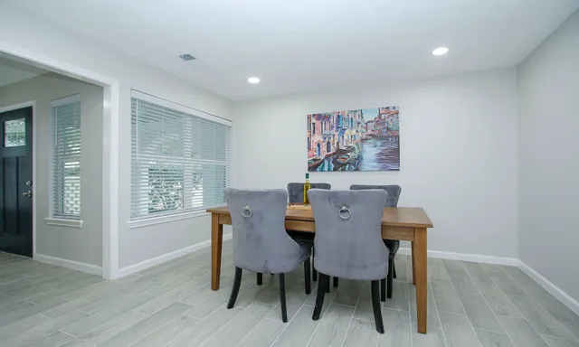 a view of a dining room with furniture window and wooden floor