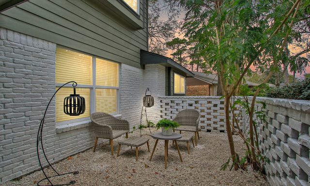 a house view with a outdoor seating