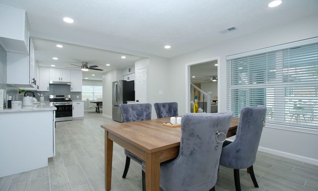 a kitchen with a table and chairs in it