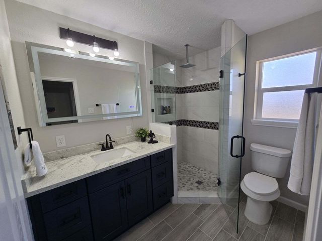 a bathroom with a sink a toilet and mirror