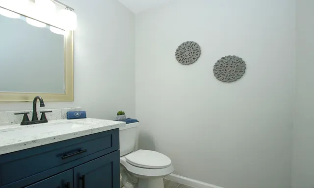 a bathroom with a sink a toilet and a mirror