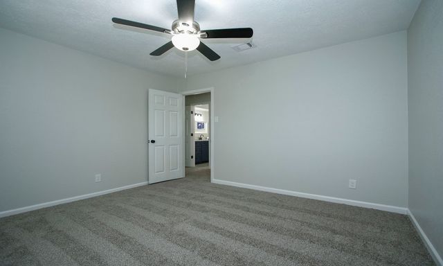 an empty room with a empty space and a ceiling fan
