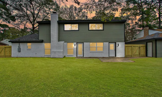 a front view of a house with a garden