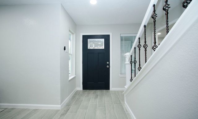 an entryway with a white walls