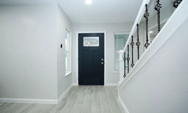 an entryway with a white walls