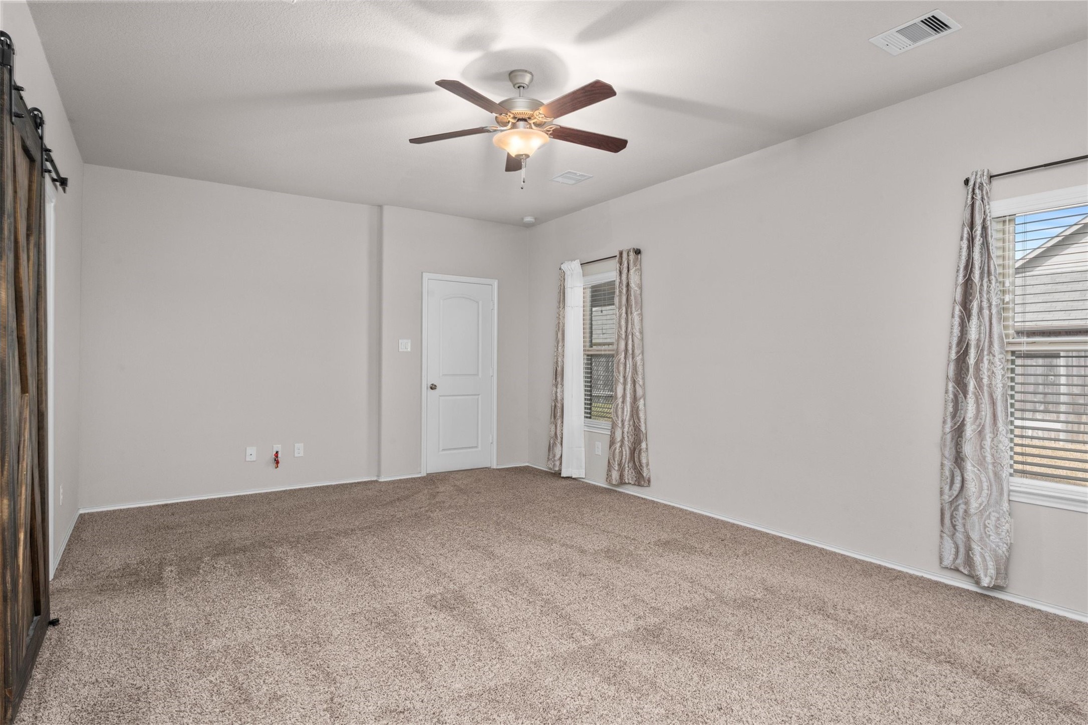5210 Adria Hills Circle Spring, TX 77389 - Photo 18 of 42 a view of an empty room with a ceiling fan and window