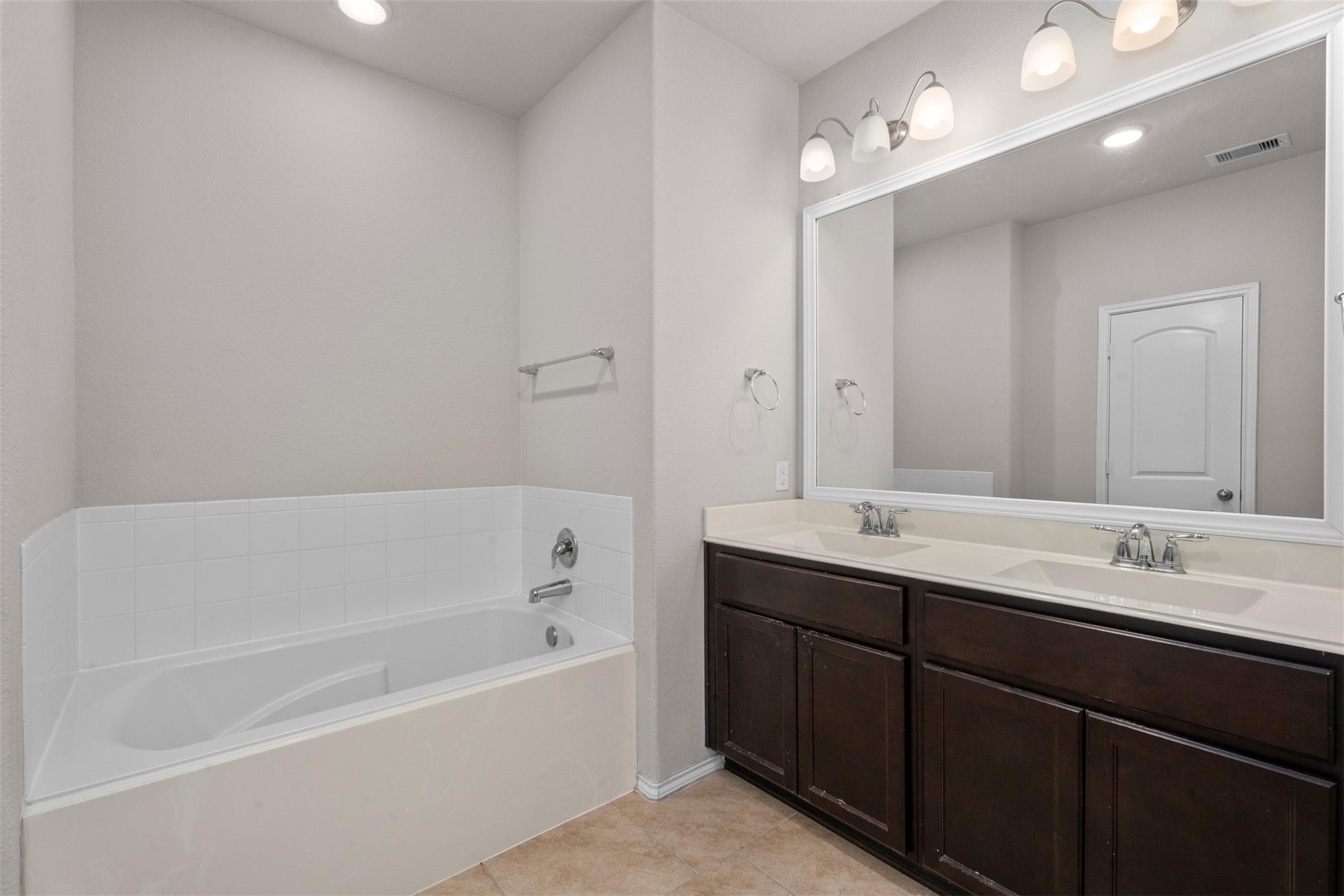 5210 Adria Hills Circle Spring, TX 77389 - Photo 20 of 42 a bathroom with a tub double sink and mirror