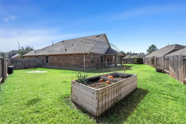 a backyard of a house with table and chairs