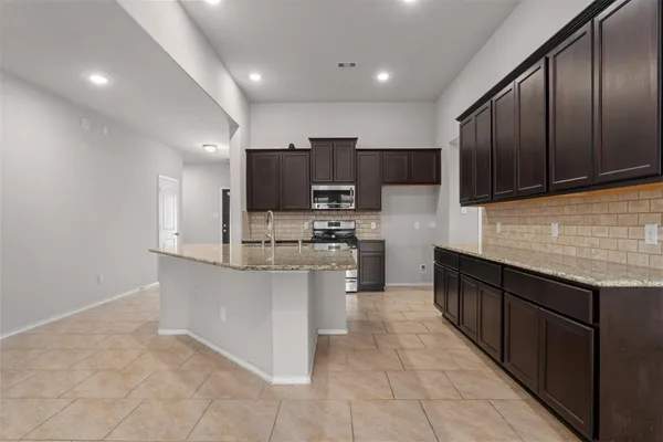 a kitchen with a sink and a mirror