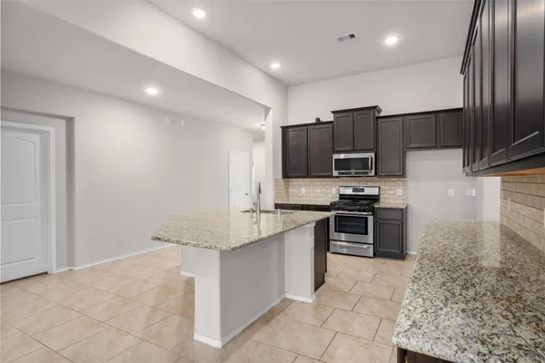 a spacious bedroom with a bed and a flat screen tv