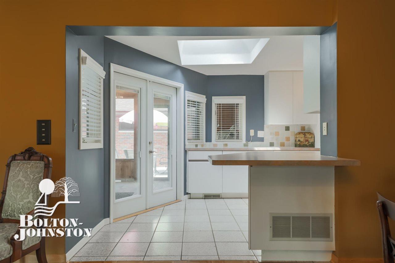 1067 Devonshire Road Grosse Pointe, MI 48230 - Photo 15 of 58 Counter eating area looking into enclosed screen porch