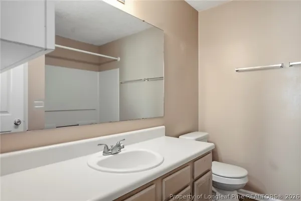 a bathroom with a sink toilet and a mirror