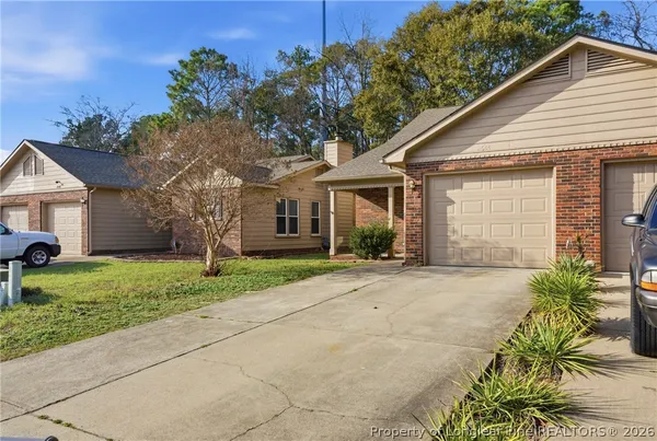 a front view of a house with a yard and a garage