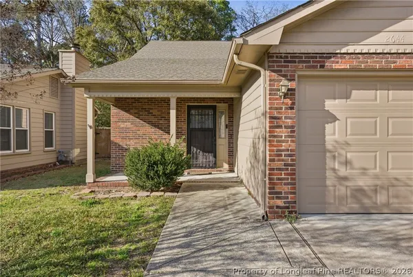 a view of a house with brick walls