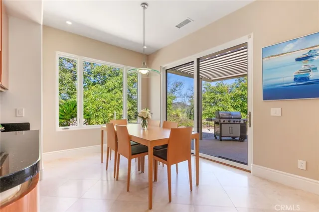 a dining room with furniture a chandelier and wooden floor