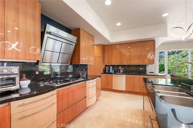 a kitchen with stainless steel appliances a sink stove and cabinets