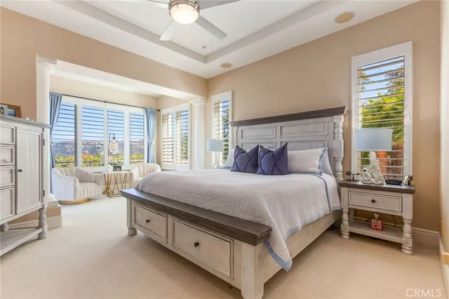 a bed sitting in a spacious bedroom next to a window
