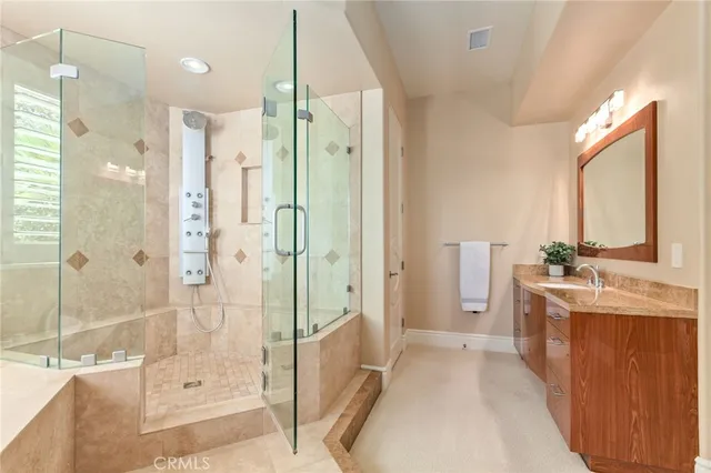 a bathroom with a double vanity sink toilet mirror and shower