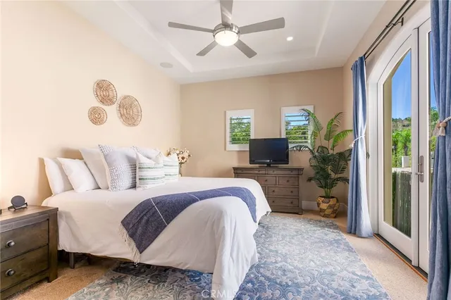 a bedroom with a large bed and a chandelier