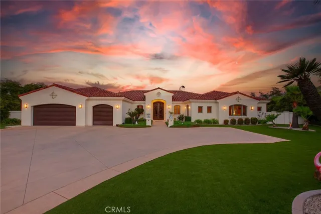 a front view of house with yard and green space