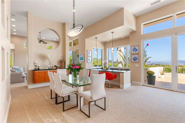 a living room with furniture a rug and a chandelier