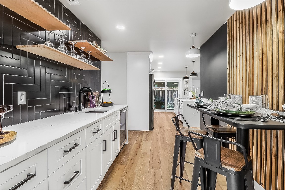 7717 Croftwood Drive Austin, TX 78749 - Photo 13 of 40 a kitchen with sink and chairs