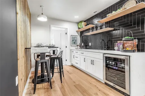 a kitchen with stainless steel appliances kitchen island granite countertop a stove a sink and a refrigerator