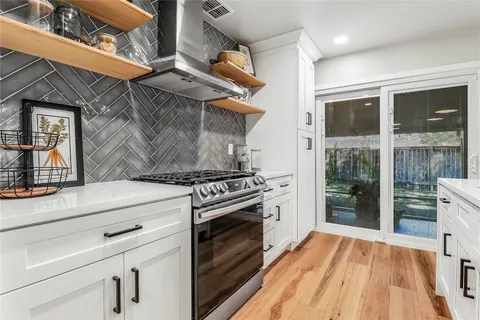 a kitchen with a stove oven and a refrigerator