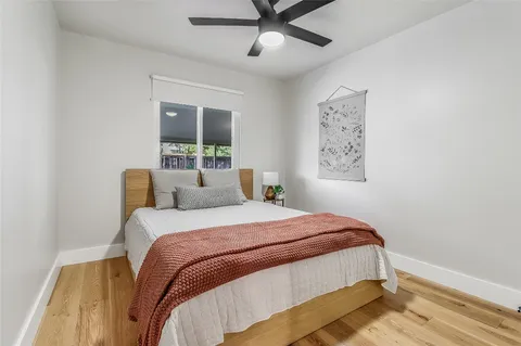 a bedroom with a large bed and a window
