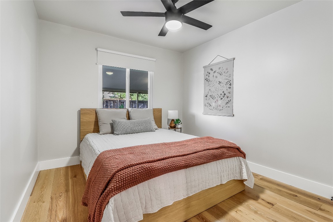 7717 Croftwood Drive Austin, TX 78749 - Photo 21 of 40 a bedroom with a large bed and a window