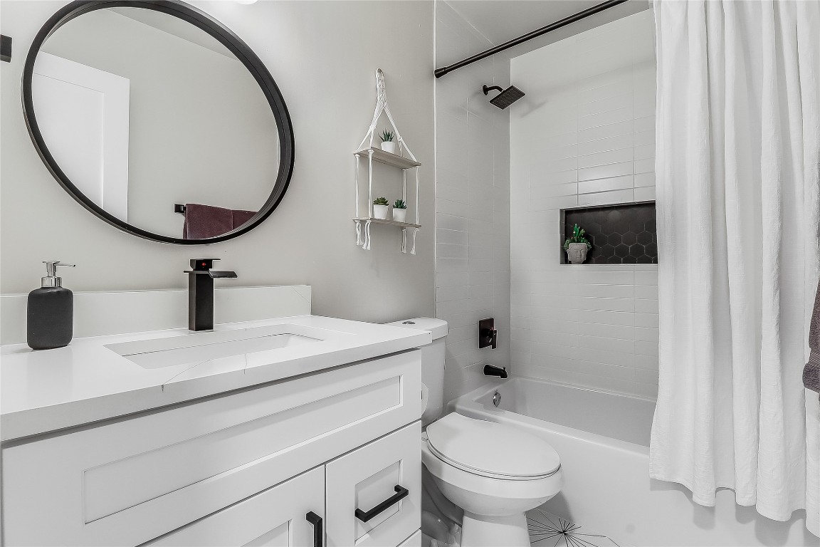 7717 Croftwood Drive Austin, TX 78749 - Photo 23 of 40 a bathroom with a sink a toilet and a mirror