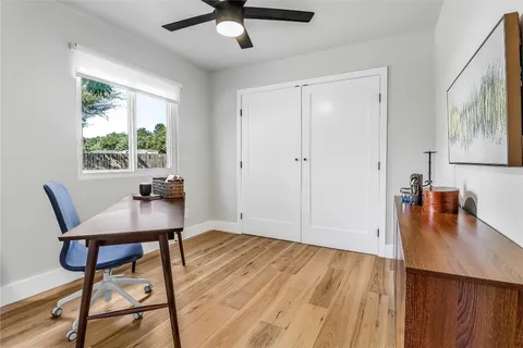 a view of a workspace with furniture and a window