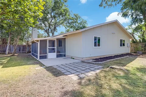 a view of a backyard with a large tree