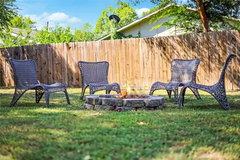 a backyard of a house with table and chairs