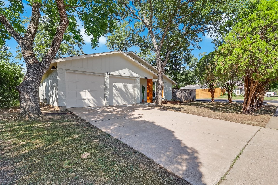 7717 Croftwood Drive Austin, TX 78749 - Photo 6 of 40 a front view of a house with a yard and garage