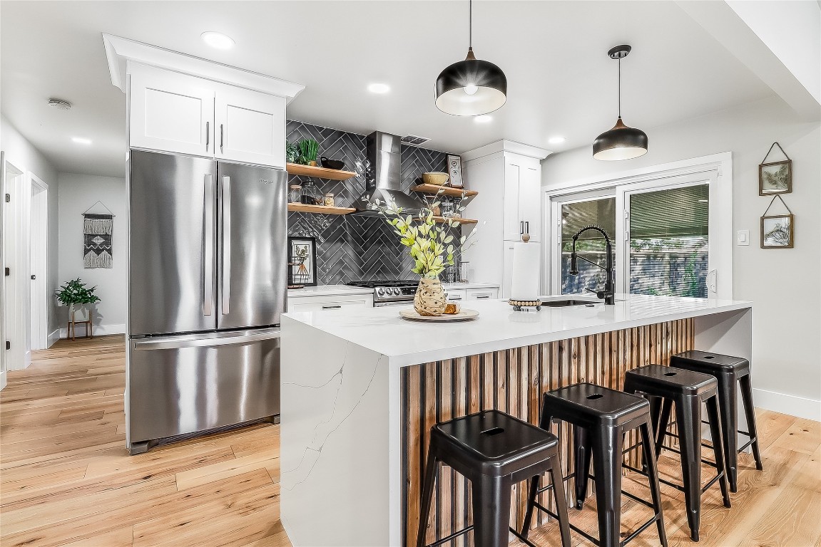 7717 Croftwood Drive Austin, TX 78749 - Photo 9 of 40 a kitchen with stainless steel appliances a dining table chairs refrigerator and stove